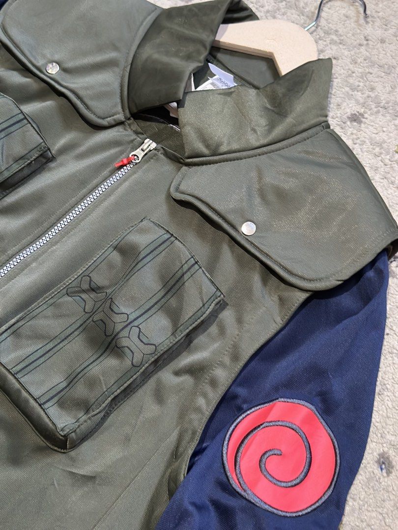 Naruto Shippuden Kakashi Hatake Full-Zip Jacket Size L (Category: Coats, Jackets and Outerwear) located in Daet. Submitted by thrifthings2018 (Listing ID 1470037215, Image 3). Description: - Official Naruto Shippuden merchandise - Kakashi Hatake inspired design with green vest and dark blue sleeves - Features iconic Uzumaki swirl symbols on the back and shoulders - Full zip front closure with functional chest pockets - Size: L (Measures 23" acros