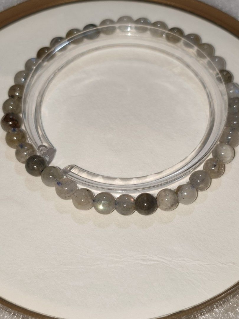Natural Labradorite Crystal Beaded Bracelet with iridescent flashes (Category: Bracelets) located in Caloocan City. Submitted by books_and_beads (Listing ID 1470107227, Image 1). Description: - Material: Genuine polished labradorite beads - Appearance: The beads are a translucent, smoky grey-green with dark natural inclusions. You can spot the subtle iridescent "flash" (blue/gold/green) on a few beads when the light hits them. - Size: 6mm beads ✨