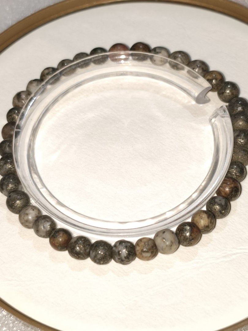 Natural Stone Bead Bracelet with Pyrite Inclusions (Category: Bracelets) located in Caloocan City. Submitted by books_and_beads (Listing ID 1470109900, Image 1). Description: - Natural stone beads featuring unique metallic pyrite flecks - Earthy mix of brown, grey, and metallic tones - Size: 5mm beads, making it a delicate, everyday piece. ✨ Benefits & Associations · Abundance & Prosperity: Pyrite is known as a stone of luck and manifestation. It