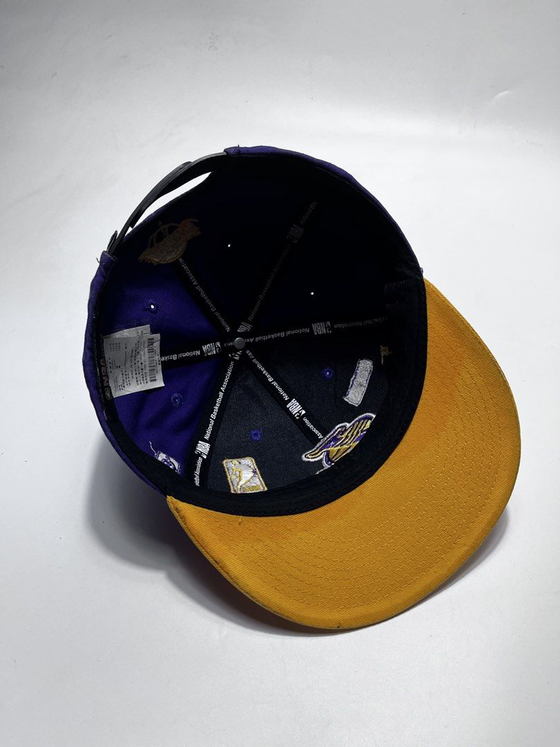 NBA Style LA Lakers Snapback Cap Purple Yellow (Category: Caps & Hats) located in Iloilo. Submitted by fromthebins.ilo2 (Listing ID 1470107111, Image 2). Description: - Authentic NBA Style Los Angeles Lakers snapback hat - Vibrant purple crown with a contrasting yellow brim and top button - Premium embroidered Lakers front logo with collectible team patches on the sides and back - Adjustable black plastic snapback closure for a custom fit - Size:
