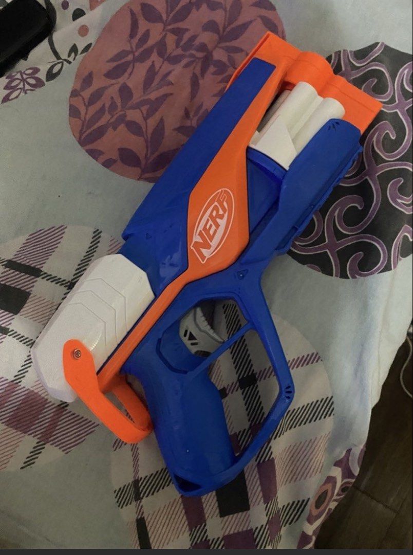 Nerf Rough Cut 2X4 Blaster (Category: Action & Battle Toys) located in Quezon City. Submitted by mg163 (Listing ID 1470034656, Image 1). Description: - Model: Nerf Rough Cut 2X4 toy blaster - Colorway: Blue, orange, and white - Action: Pump-action mechanism with 4 front barrels - Features: Built-in handle grip and tactical rail underneath - Condition: Fully functional for target practice or indoor battles - Note: Darts available 5 rounds .