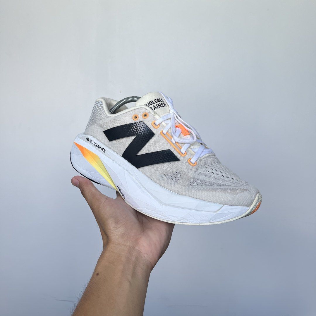 New Balance FuelCell SuperComp Carbon Plated (Category: Sneakers) located in Iligan City. Submitted by nick.segualan (Listing ID 1470047636, Image 1). Description: - Brand/Model: New Balance FuelCell SuperComp Trainer - Size: 11.5 US / 28.5 cm (2E Wide fit) - Colorway: Cream white upper with black branding and orange-yellow gradient midsole - Condition: Worn a few times, minimal outsole wear - Features: High stack height, incredibly bouncy foam f