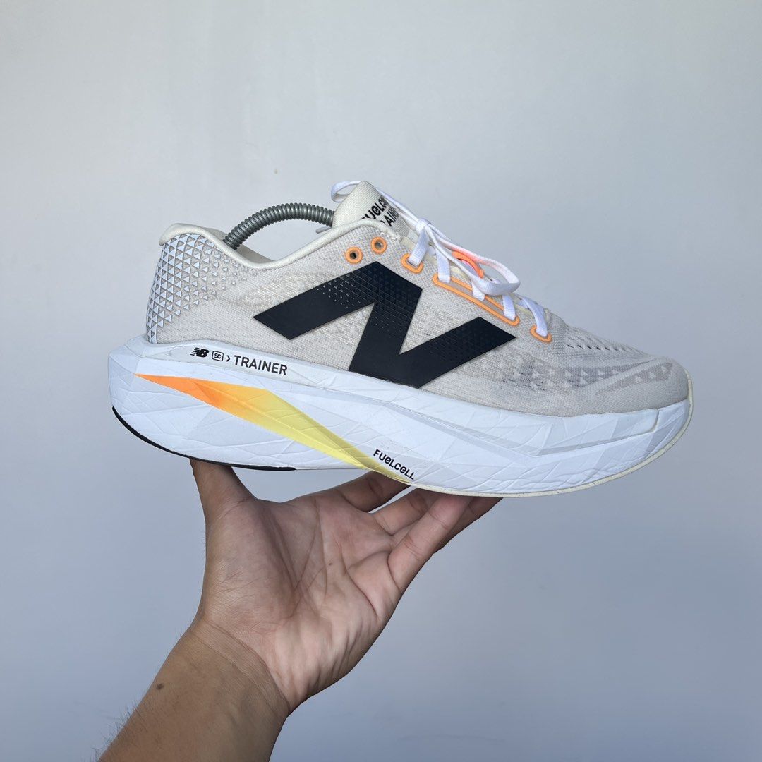 New Balance FuelCell SuperComp Carbon Plated (Category: Sneakers) located in Iligan City. Submitted by nick.segualan (Listing ID 1470047636, Image 3). Description: - Brand/Model: New Balance FuelCell SuperComp Trainer - Size: 11.5 US / 28.5 cm (2E Wide fit) - Colorway: Cream white upper with black branding and orange-yellow gradient midsole - Condition: Worn a few times, minimal outsole wear - Features: High stack height, incredibly bouncy foam f