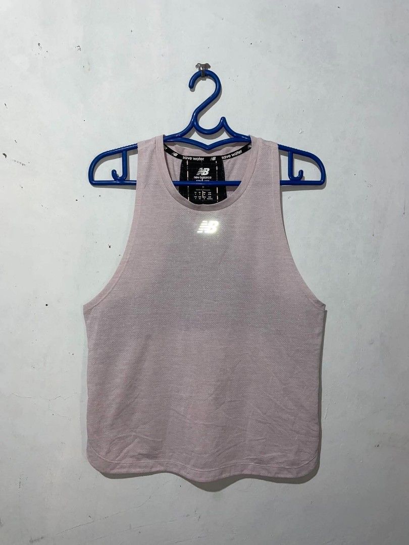 New Balance Running Tank Top Size Medium (Category: Activewear) located in Meycauayan. Submitted by epicforest_231b9d (Listing ID 1469948229, Image 2). Description: New Balance running tank top in pale pink. Size Medium (Asia). Breathable mesh fabric up front, contrast black panel with reflective grid pattern on the back. Reflective New Balance logo hits on the chest and lower back. Curved hem finish. Excellent condition..