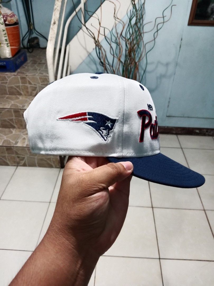 New England Patriots Snapback Cap (Category: Caps & Hats) located in Bacolod City. Submitted by jorengrate26639 (Listing ID 1470076991, Image 2). Description: - Authentic New England Patriots snapback hat - Color: White and navy blue with matching eyelets and top button - Front: Bold embroidered team name - Side: Classic flying Elvis logo embroidery - Back: Adjustable plastic snap closure for a custom fit - Structure: Clean, structured panels - C