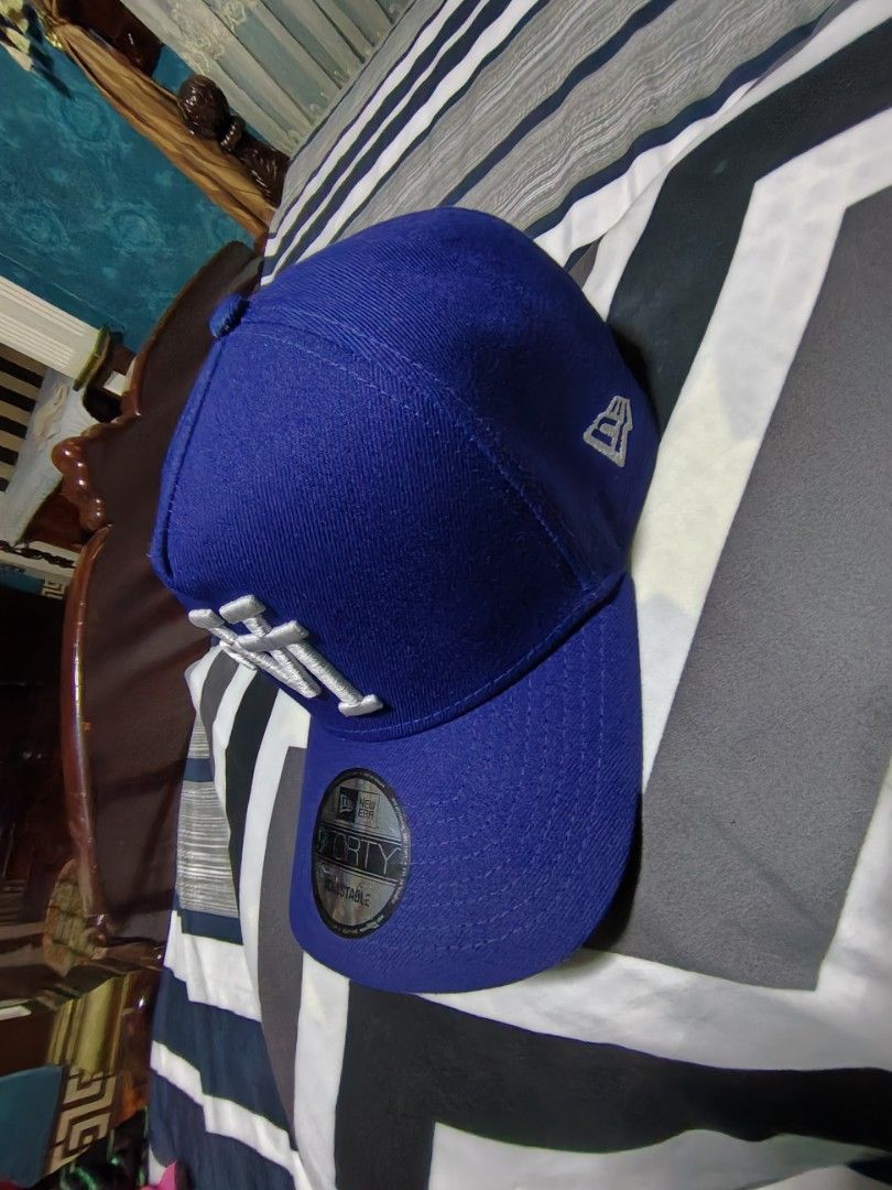New Era 9FORTY LA Dodgers Blue Adjustable Cap (Category: Caps & Hats) located in Manila. Submitted by snooks1938 (Listing ID 1470116480, Image 3). Description: Up For Sale.. NEW ERA LA CAP UPSIDE DOWN LOGO EDITION.. GUARANTEED AUTHENTIC OR TRIPLE UR MONEY BACK.. GUARANTEED.. - Brand: New Era 9FORTY - Color: Royal Blue with White LA Dodgers embroidery - Details: Small New Era flag logo on the side - Condition: Brand new with flat sticker still att