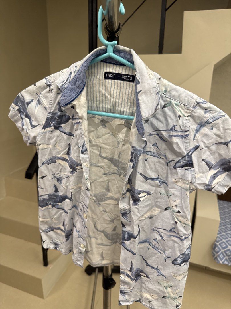 Next Shark Print Short Sleeve Shirt (Category: Babies & Kids Fashion) located in Manila. Submitted by __nix (Listing ID 1470013722, Image 3). Description: - Brand: Next - Style: Short-sleeve button-up shirt - Color/Design: Light blue with all-over shark and marine animal print - Details: Collar neck with blue stripe interior lining - Material: Lightweight fabric - Condition: Great for casual summer wear.