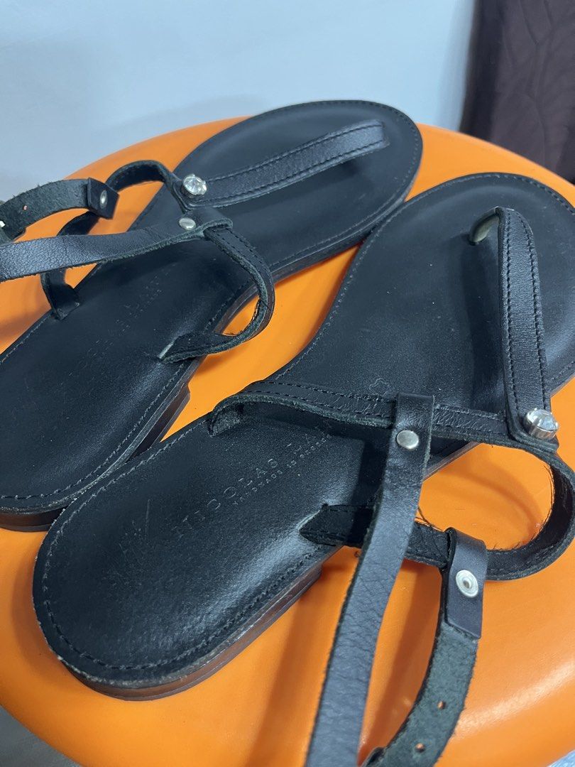 NICOLAS Handmade in Greece Black Leather Sandals (Category: Flats & Sandals) located in Valenzuela. Submitted by sofiasticated.decluttering (Listing ID 1470060115, Image 3). Description: - Brand: NICOLAS (Handmade in Greece) - Material: Genuine black leather - Style: Thong sandals with ankle straps and buckle closure - Details: Eye-catching rhinestone embellishments on the front strap - Sole: Flat design, very comfortable for daily wear - Conditi