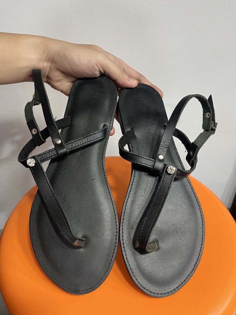 NICOLAS Handmade in Greece Black Leather Sandals (Category: Flats & Sandals) located in Valenzuela. Submitted by sofiasticated.decluttering (Listing ID 1470060115, Image 2). Description: - Brand: NICOLAS (Handmade in Greece) - Material: Genuine black leather - Style: Thong sandals with ankle straps and buckle closure - Details: Eye-catching rhinestone embellishments on the front strap - Sole: Flat design, very comfortable for daily wear - Conditi