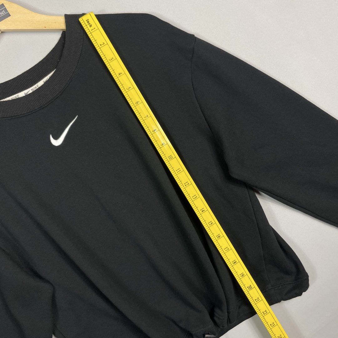 NIKE | Black Drawstring Crewneck (Category: Coats, Jackets and Outerwear) located in Norzagaray. Submitted by sevenjscloset (Listing ID 1470008722, Image 3). Description: - Brand/Item: Nike Black Drawstring Crewneck Sweatshirt - Design: Small embroidered white swoosh on chest, large swoosh print on back - Fit Feature: Adjustable drawstring hem for a customized fit - Measurements: Length 22 inches, Width 17.5 inches - Model Reference: 5'2" tall, 5