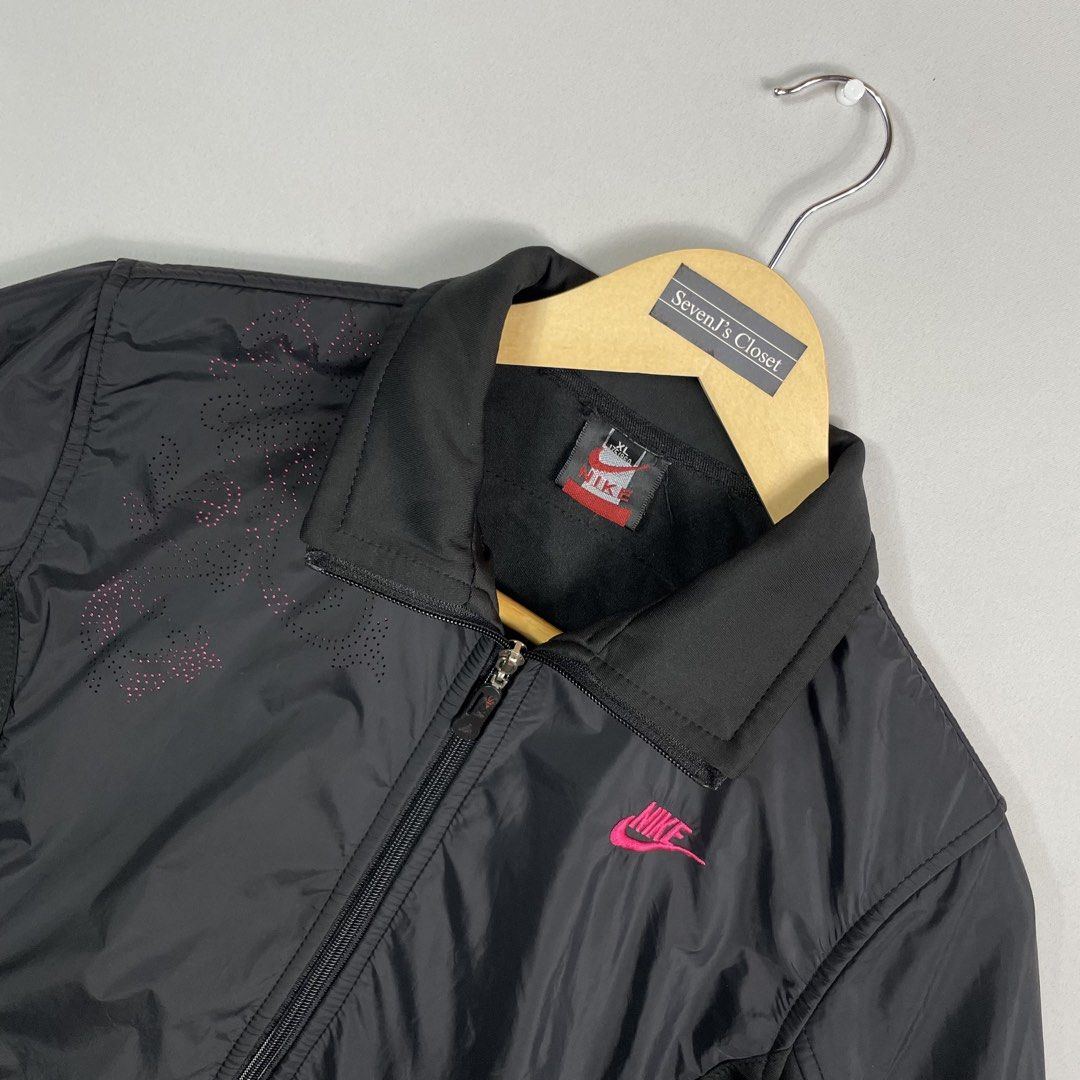 NIKE | Black Lightweight Jacket (Category: Coats, Jackets and Outerwear) located in Manila. Submitted by sevenjscloset (Listing ID 1470000446, Image 2). Description: - Brand: Nike - Color: Black with pink accents - Size: XL on tag (Measures 22" length x 17" width) - Features: Full zip closure, high collar, front pockets, front chest graphic, and large Nike spellout on the back - Condition: 9/10, flawless and well-maintained - Lightweight and styl