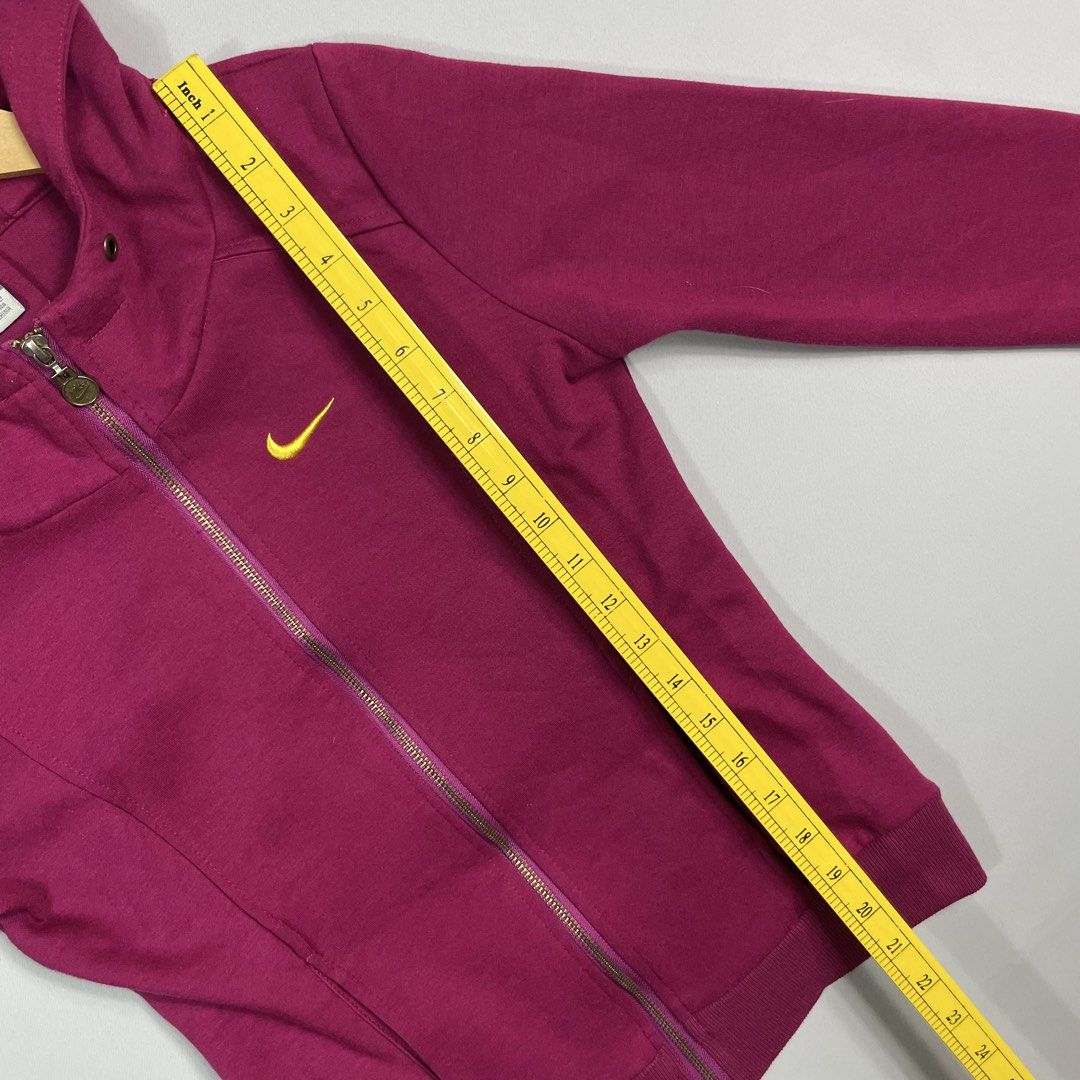 NIKE | Maroon Zip-Up Hoodie (Category: Coats, Jackets and Outerwear) located in Manila. Submitted by sevenjscloset (Listing ID 1470001904, Image 3). Description: - Brand/Style: Authentic Maroon Nike Zip-Up Hoodie - Details: Yellow embroidered Swoosh logo, zip closure, adjustable drawstring hood, and front pockets - Size on tag: Medium - Actual measurements: 21 inches (length) x 15 inches (width) - Model reference: 5'2" height, 50kg weight - Condi
