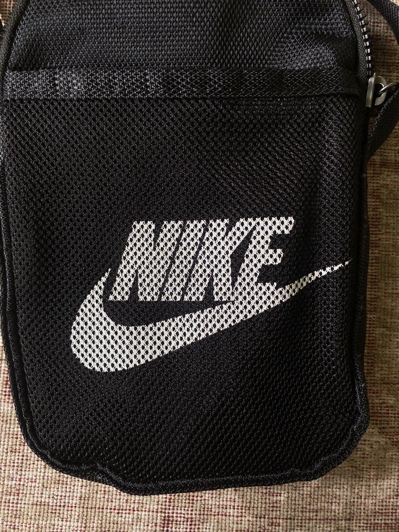 Nike Black Crossbody Bag (Category: Sling Bags) located in Manila. Submitted by diporosmoh43681 (Listing ID 1469976211, Image 2). Description: - Brand: Nike - Color: Classic black with white Nike logo - Material: Durable, high-quality nylon - Closure: Top zipper with black pull cord - Storage: Handy front mesh pocket for easy access - Strap: Fully adjustable for a comfortable fit - Perfect for: Carrying daily essentials like your phone, wallet, a