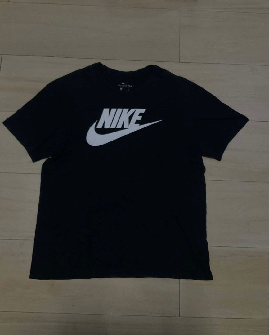 Nike Black Graphic Tee (Category: Tshirts & Polo Shirts ) located in Manila. Submitted by thrifty111 (Listing ID 1470091027, Image 1). Description: - Brand: Nike - Color: Black with large white logo on front - Size: XL - Design: Short sleeves, crew neck - Material: Comfortable cotton feel - Style: Classic everyday casual wear, easy to pair with jeans or shorts 21x27.5.