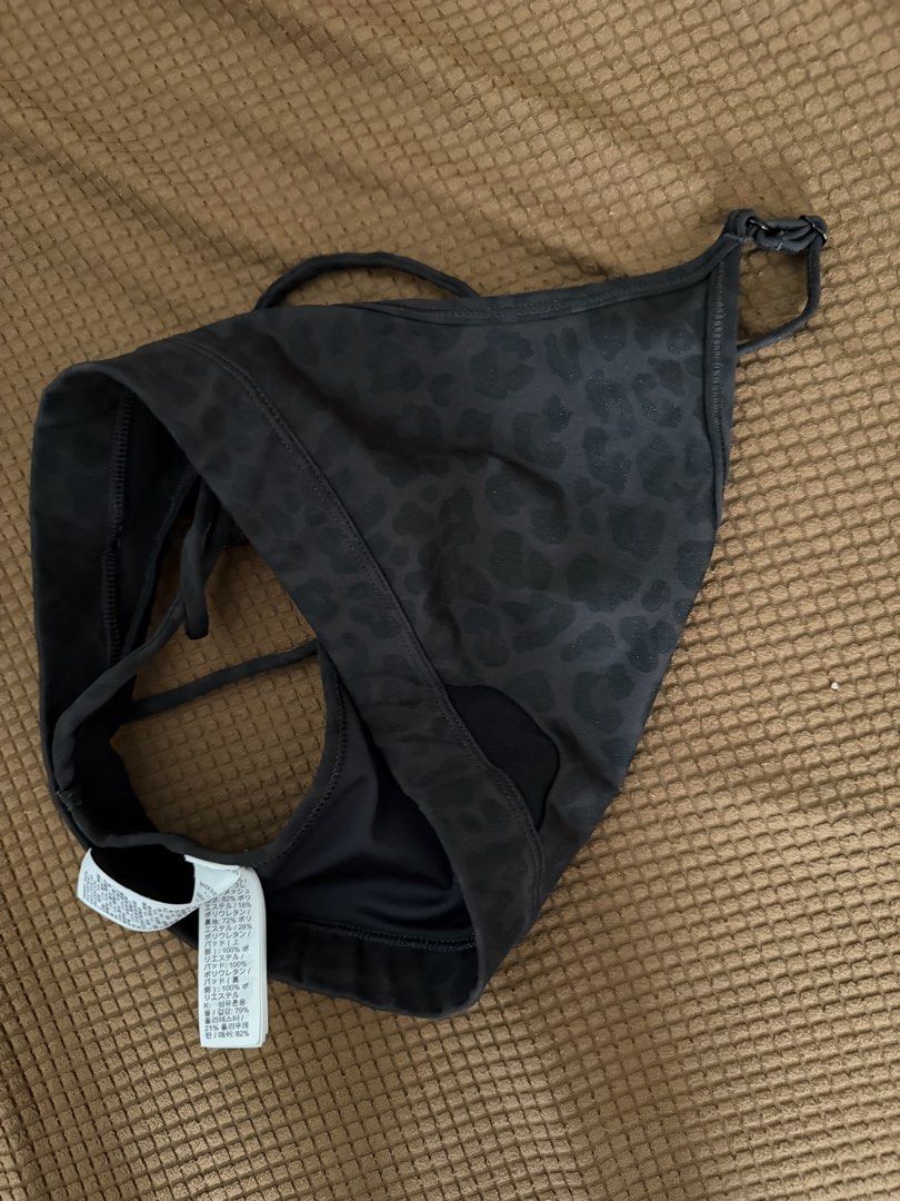 Nike Black Leopard Print Sports Bra (Category: Activewear) located in Pasay City. Submitted by gold1001 (Listing ID 1469958791, Image 3). Description: - Black with a subtle all-over leopard print pattern - Adjustable cross-back straps for a custom fit - Stylish small cutout detail at the front hem - Breathable mesh panel in the back - Iconic white Nike Swoosh logo on the left chest.
