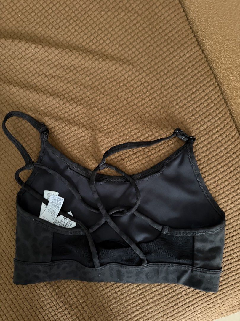 Nike Black Leopard Print Sports Bra (Category: Activewear) located in Pasay City. Submitted by gold1001 (Listing ID 1469958791, Image 2). Description: - Black with a subtle all-over leopard print pattern - Adjustable cross-back straps for a custom fit - Stylish small cutout detail at the front hem - Breathable mesh panel in the back - Iconic white Nike Swoosh logo on the left chest.