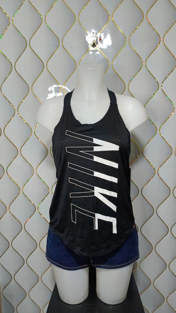 Nike Black Workout Tank Top with Large Vertical Logo (Category: Activewear) located in Manila. Submitted by zariyah.1986 (Listing ID 1469954866, Image 2). Description: - Brand: Nike - Color: Classic black with a bold vertical white logo - Design: Stylish strap detailing on the back featuring the signature 'Just Do It' text - Fit: Racerback cut designed for a full range of motion - Fabric: Lightweight and breathable to keep you cool and dry - Cond