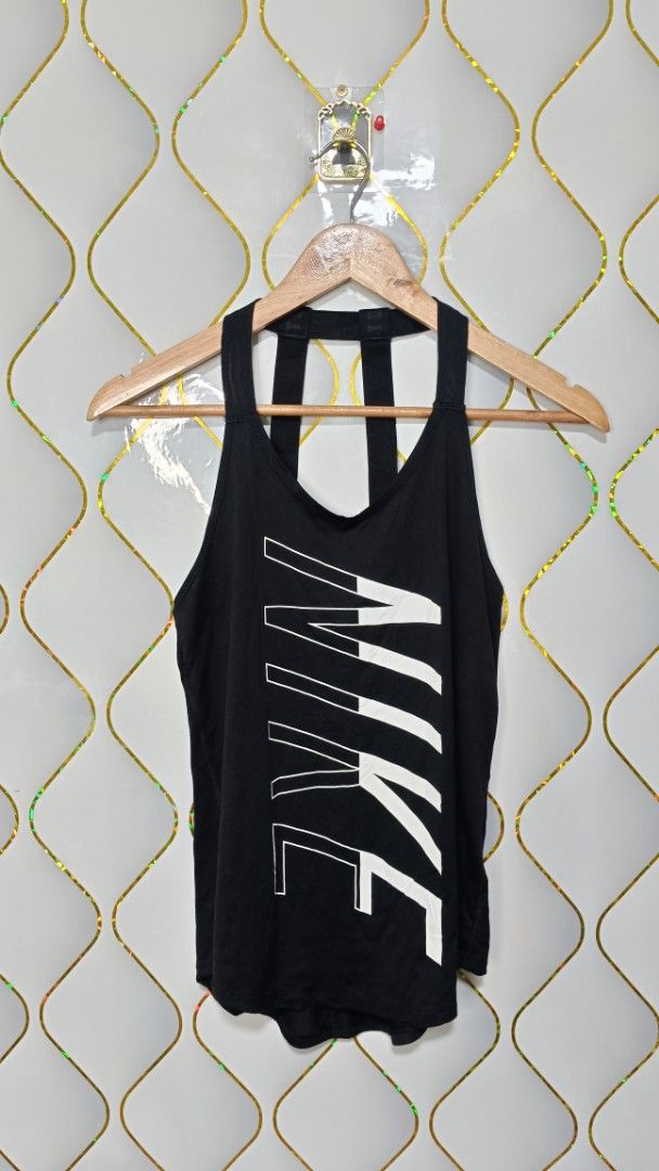 Nike Black Workout Tank Top with Large Vertical Logo (Category: Activewear) located in Manila. Submitted by zariyah.1986 (Listing ID 1469954866, Image 1). Description: - Brand: Nike - Color: Classic black with a bold vertical white logo - Design: Stylish strap detailing on the back featuring the signature 'Just Do It' text - Fit: Racerback cut designed for a full range of motion - Fabric: Lightweight and breathable to keep you cool and dry - Cond