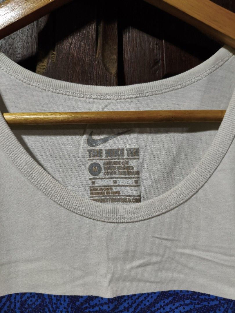 Nike Blue Pattern Box Logo White Tank Top Medium (Category: Activewear) located in Bayambang. Submitted by rajuergui76226 (Listing ID 1470008862, Image 2). Description: - Brand: Nike - Item: Tank Top - Color: White with blue pattern box logo - Size: Medium - Measurements: 19 inches across chest, 28 inches down - Material: Comfortable cotton - Style: Classic athletic cut, great for gym or casual wear.