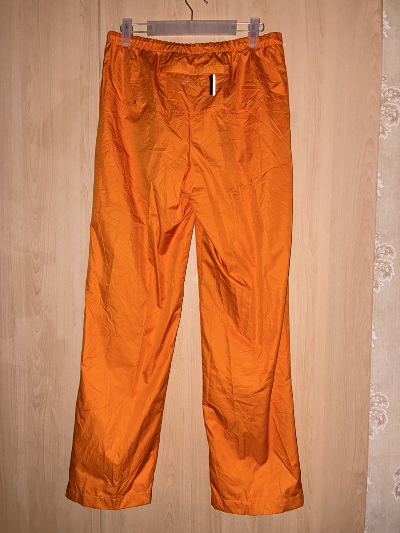 Nike Clima-Fit Orange Track Pants (Category: Joggers) located in Placer. Submitted by talaalond61563 (Listing ID 1469977532, Image 2). Description: - Brand: Nike - Color: Bright orange with silver embroidered swoosh - Tech: Clima-Fit for weather protection - Fit: Comfortable elastic waistband - Size: Small on tag fit up to Large - Features: Zippered ankle cuffs, breathable mesh lining, and a back pocket with a reflective zipper pull - Style: Vint