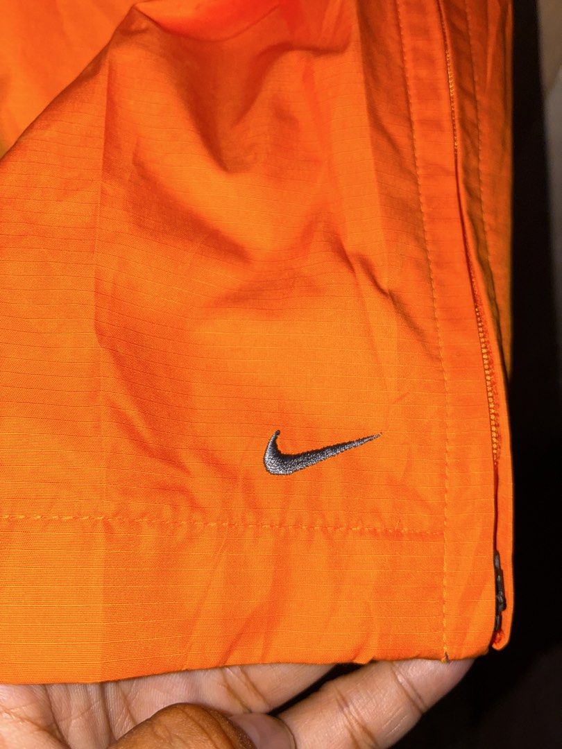 Nike Clima-Fit Orange Track Pants (Category: Joggers) located in Placer. Submitted by talaalond61563 (Listing ID 1469977532, Image 3). Description: - Brand: Nike - Color: Bright orange with silver embroidered swoosh - Tech: Clima-Fit for weather protection - Fit: Comfortable elastic waistband - Size: Small on tag fit up to Large - Features: Zippered ankle cuffs, breathable mesh lining, and a back pocket with a reflective zipper pull - Style: Vint