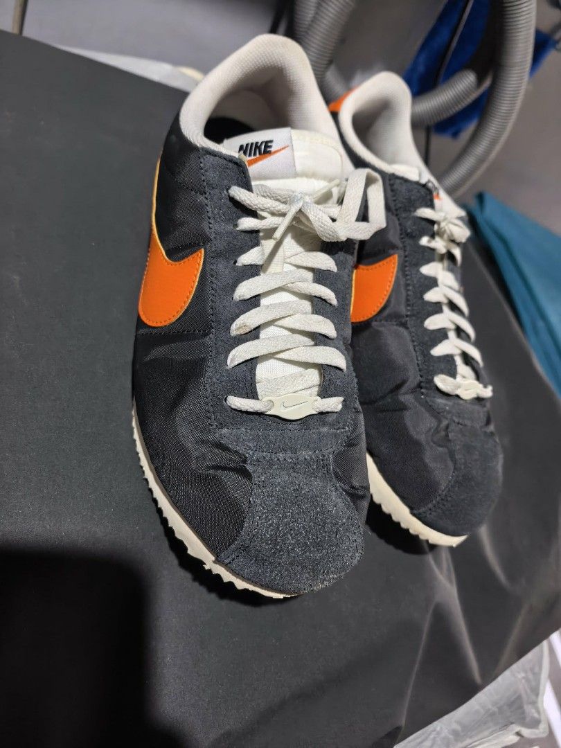 Nike Cortez Nylon Black Orange Sneakers (Category: Casual Shoes) located in Manila. Submitted by anjbrtlm (Listing ID 1470021638, Image 2). Description: - Brand/Model: Nike Cortez retro running sneakers - Colorway: Black nylon upper with bright orange swoosh and white laces - Size: US 9.5 / UK 8.5 / EUR 43.5 / CM 27.5 - Features: Iconic textured soles and timeless vintage design.