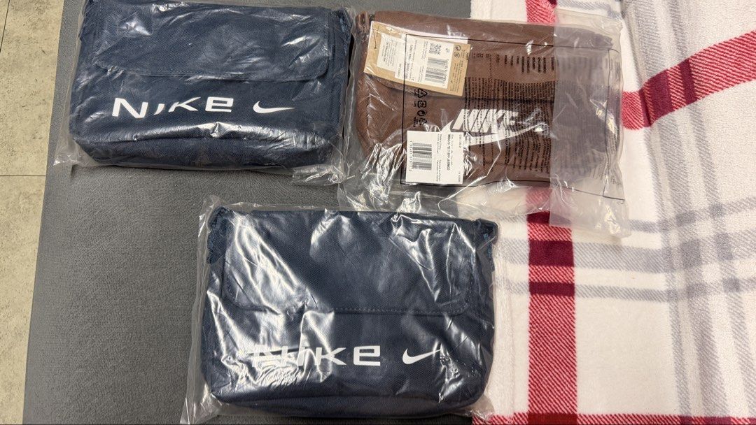Nike Crossbody Bag Various Colors (Category: Cross-body Bags) located in Cavite. Submitted by rhea0218 (Listing ID 1470030931, Image 1). Description: - authentic Nike crossbody bags in original sealed packaging with tags - Colors: 2 dark blue units and 1 brown unit - Adjustable strap for a comfortable, custom fit - Secure flap closure to keep your essentials safe - Stylish design featuring the large white Nike logo on the front - Brand new and ne