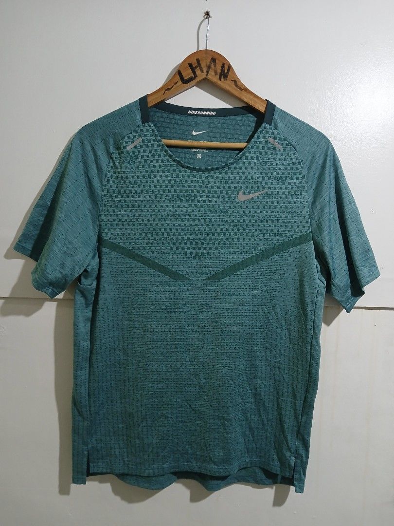 Nike Dri-FIT ADV Techknit Running Top (Category: Activewear) located in Taguig. Submitted by thriftnilhan (Listing ID 1470081411, Image 1). Description: - Brand: Nike - Model: Dri-FIT ADV Running Top - Style Code: DM4753-309 - Size: Small - Color: Teal Green - Advanced breathable knit for high-heat cooling - Reflective Swoosh and strip details for low-light safety - Lightweight, stretchy material for maximum mobility.
