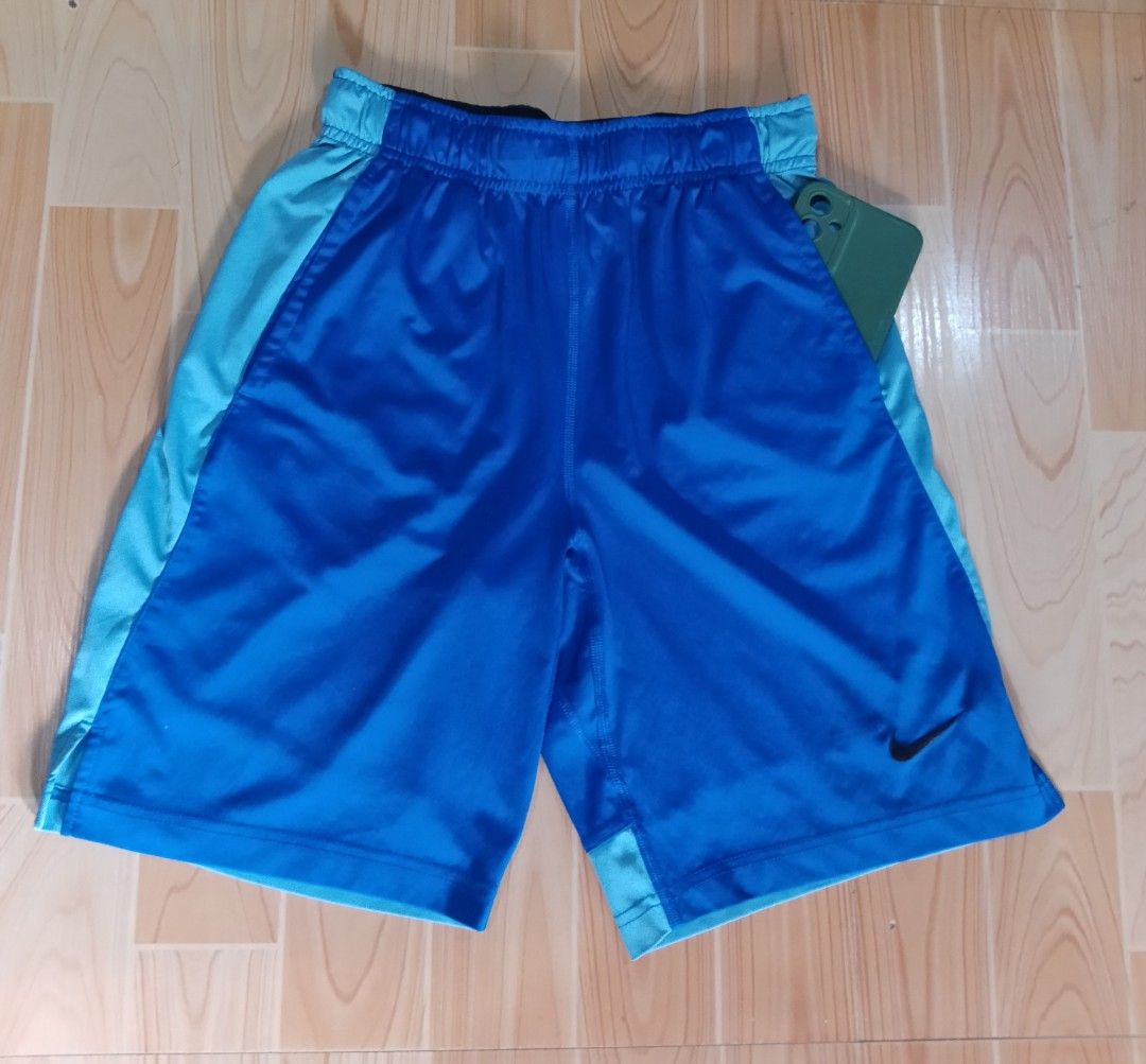 Nike Dri-FIT Blue Athletic Shorts (Category: Shorts) located in San Jose del Monte. Submitted by azetor (Listing ID 1469995269, Image 2). Description: - Brand: Nike - Color: Royal blue and light blue with contrast side panels - Material: Dri-FIT (keeps you dry and comfortable) - Features: Elastic waistband with adjustable black drawstring, and Nike swoosh logo - Ideal for: Running, gym workouts, or casual wear - size medium on tags - Youth size -