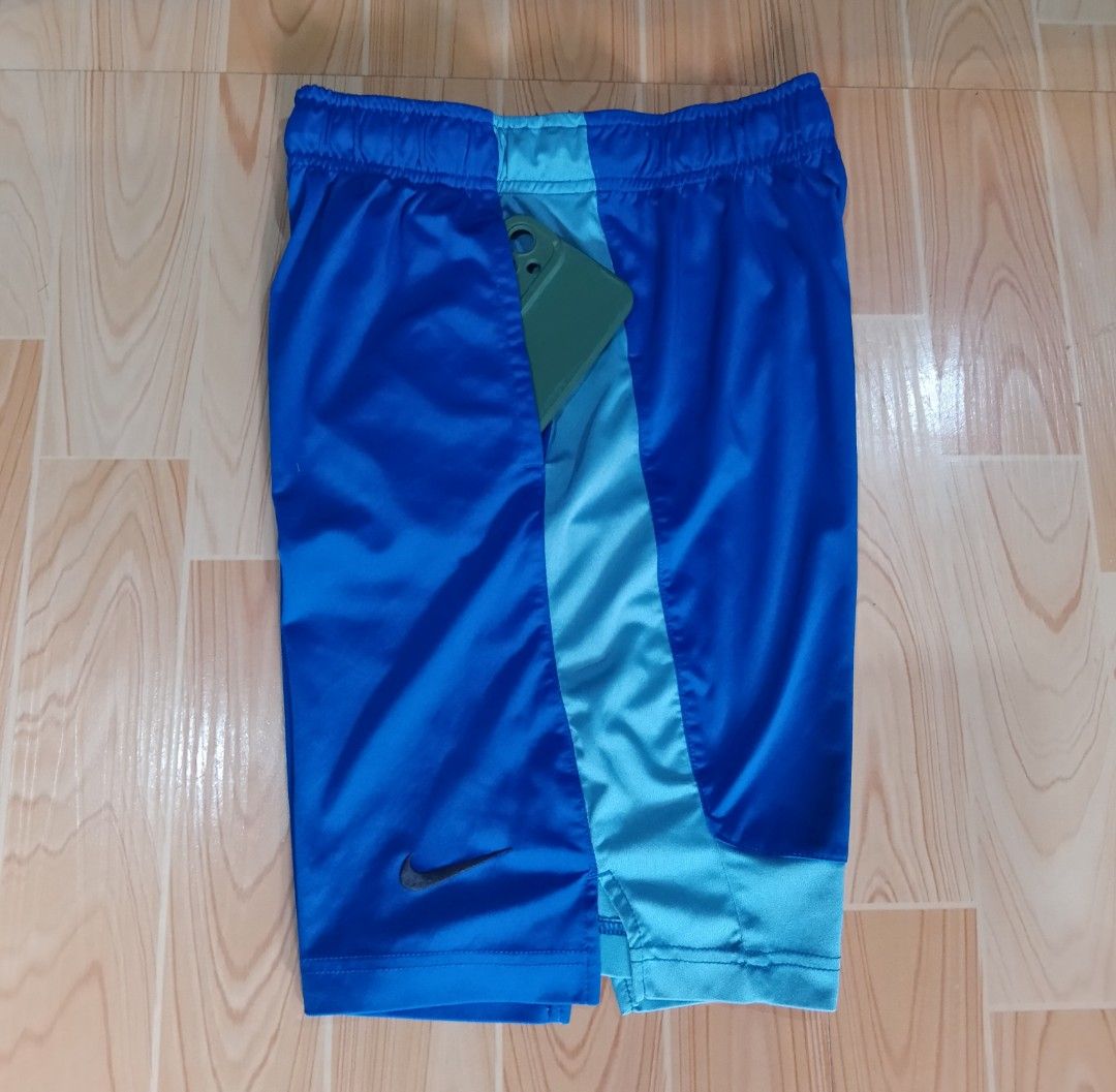 Nike Dri-FIT Blue Athletic Shorts (Category: Shorts) located in San Jose del Monte. Submitted by azetor (Listing ID 1469995269, Image 1). Description: - Brand: Nike - Color: Royal blue and light blue with contrast side panels - Material: Dri-FIT (keeps you dry and comfortable) - Features: Elastic waistband with adjustable black drawstring, and Nike swoosh logo - Ideal for: Running, gym workouts, or casual wear - size medium on tags - Youth size -