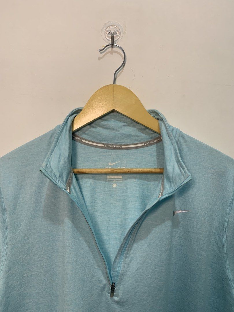 Nike Dri-FIT Running Half Zip Pullover Light Blue XL (Category: Activewear) located in Davao. Submitted by legitseller1111 (Listing ID 1470128035, Image 3). Description: - Brand: Nike - Style: Running half-zip pullover - Color: Light blue - Size: XL - Material: Dri-FIT moisture-wicking fabric - Features: Stand collar with zipper garage, thumbholes on cuffs for warmth and secure fit, and reflective swoosh logo for visibility -Need wash(See last ph