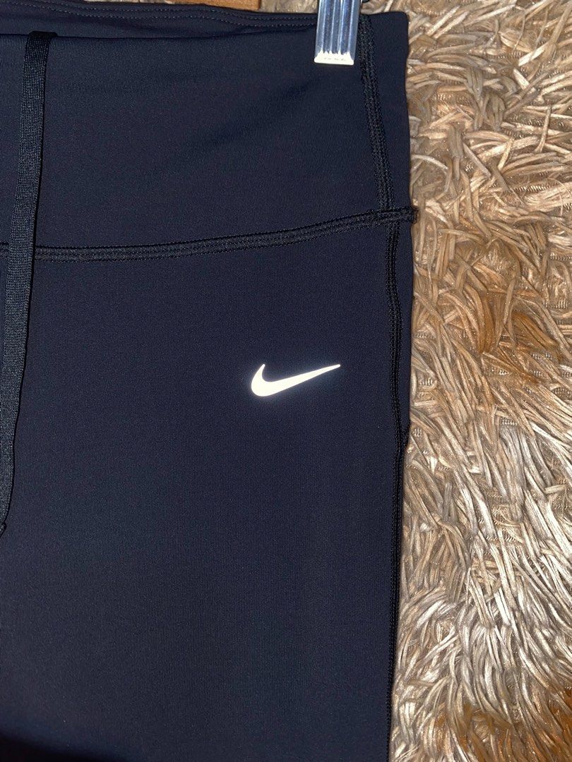 Nike Dri-FIT Running Leggings Black (Category: Activewear) located in Butuan. Submitted by jc13thrifts (Listing ID 1469962810, Image 3). Description: - Brand: Nike - Color: Black - Technology: Dri-FIT moisture-wicking material - Fit: Slim fit with super stretchy fabric for maximum mobility - Waistband: Adjustable drawstring featuring repeated Nike Running lettering - Storage: Convenient back waist zipper pocket for essentials - Safety: Reflective