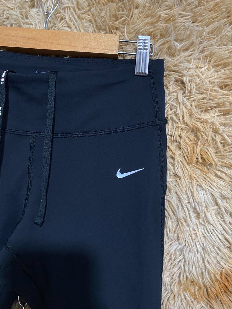 Nike Dri-FIT Running Leggings Black (Category: Activewear) located in Butuan. Submitted by jc13thrifts (Listing ID 1469962810, Image 2). Description: - Brand: Nike - Color: Black - Technology: Dri-FIT moisture-wicking material - Fit: Slim fit with super stretchy fabric for maximum mobility - Waistband: Adjustable drawstring featuring repeated Nike Running lettering - Storage: Convenient back waist zipper pocket for essentials - Safety: Reflective