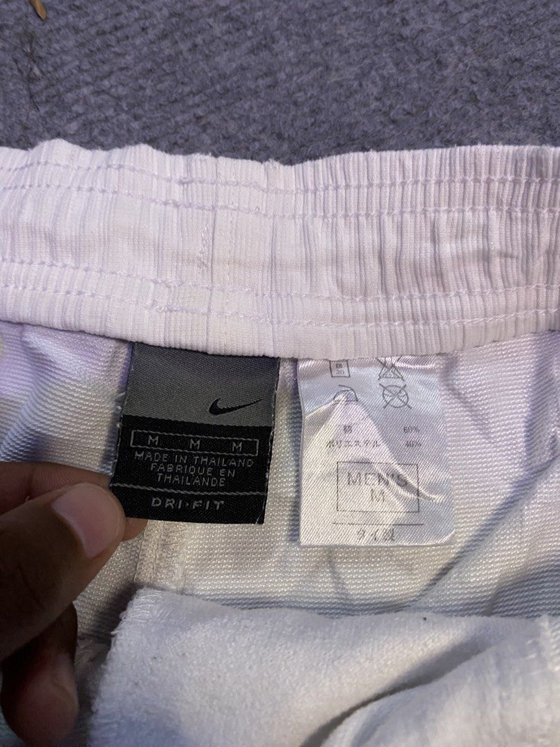 Nike Dri-FIT White Shorts Men's Medium (Category: Shorts) located in Maria Aurora. Submitted by mightypenguin.f7ca53 (Listing ID 1470056689, Image 3). Description: - Brand: Nike - Item: Dri-FIT Shorts - Size: Men's Medium - Origin: Made in Thailand - Color: White - Features: Elastic waistband, zip back pocket, textured fabric, side slits at the hem - Branding: Embroidered Nike swoosh on lower left leg.