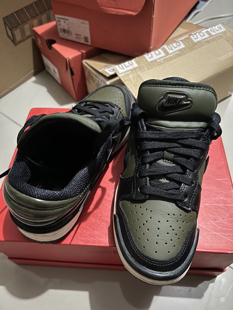 Nike Dunk Low Twist Medium Olive Black (Category: Sneakers) located in Quezon City. Submitted by jamsweetjam (Listing ID 1470036742, Image 3). Description: Nike Dunk Low in medium olive and black colourway. Classic low-top basketball silhouette with leather upper. Puffy tongue with embossed Nike logo patch. Clean white midsole paired with a dark outsole. Black laces threaded through the front. Minor wear along the edges of the sole, otherwise sol