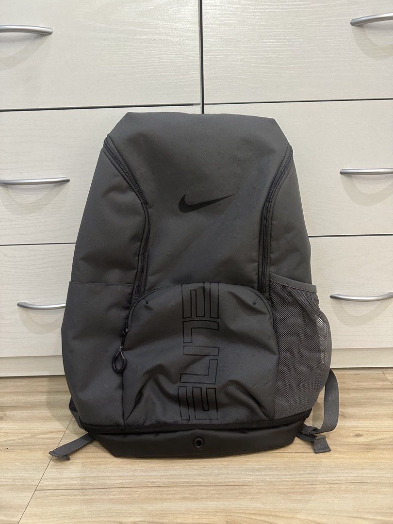 Nike Elite Bag V3 - Gray (Category: Backpacks) located in Antipolo. Submitted by kicksnmists.ph (Listing ID 1470100537, Image 1). Description: - Brand: Nike Elite Backpack - Color: Dark grey with bold vertical ELITE branding - Comfort: Air Max cushioning in shoulder straps for heavy loads + adjustable sternum strap - Storage: Spacious main compartment, front pocket, and mesh side water bottle pocket - Durability: Tough black bottom panel - Condit