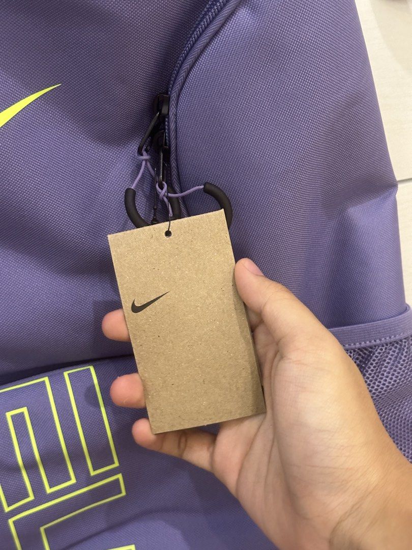 Nike Elite Bag V3 - Purple Amethyst (Category: Backpacks) located in Antipolo. Submitted by kicksnmists.ph (Listing ID 1470100566, Image 3). Description: - Authentic Nike Elite Backpack in Purple and Lime Green - Large 32L capacity with spacious main compartment - Style code: HM9965-527 (Original hangtag attached) - Convenient mesh side pockets for water bottles or essentials - Comfortable padded shoulder straps for all-day wear - Ideal for schoo