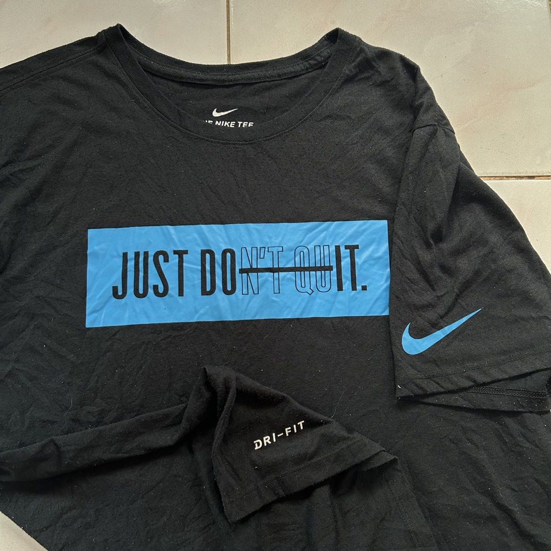Nike Just Don't Quit 🔥 (Category: Tshirts & Polo Shirts ) located in Jinoba-an. Submitted by eegiboy (Listing ID 1470004304, Image 3). Description: - Brand: Nike - Item: Athletic T-Shirt - Size: Men's XL - Color: Black with light blue graphic ('JUST DON'T QUIT' with 'DON'T' crossed out) - Details: Small blue Nike swoosh on left sleeve, 'DRI-FIT' printed near hem - Material: 75% recycled polyester, 13% organic cotton, 12% rayon - Fit: Standard at