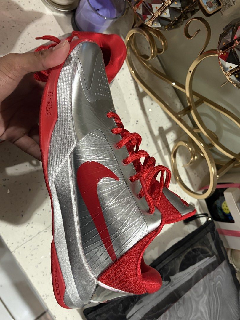 Nike Kobe 5 Protro Caitlin Clark Metallic Silver Red (Category: Sneakers) located in Davao. Submitted by lewgrover (Listing ID 1470019564, Image 2). Description: - Model: Nike Kobe 5 Protro basketball sneakers - Colorway: Metallic silver upper with vibrant red accents and laces - Details: Signature Kobe sheath logo on tongue and red signature on chrome heel counter - Sole: Red rubber outsole with visible carbon fiber shank plate - Condition: Clea