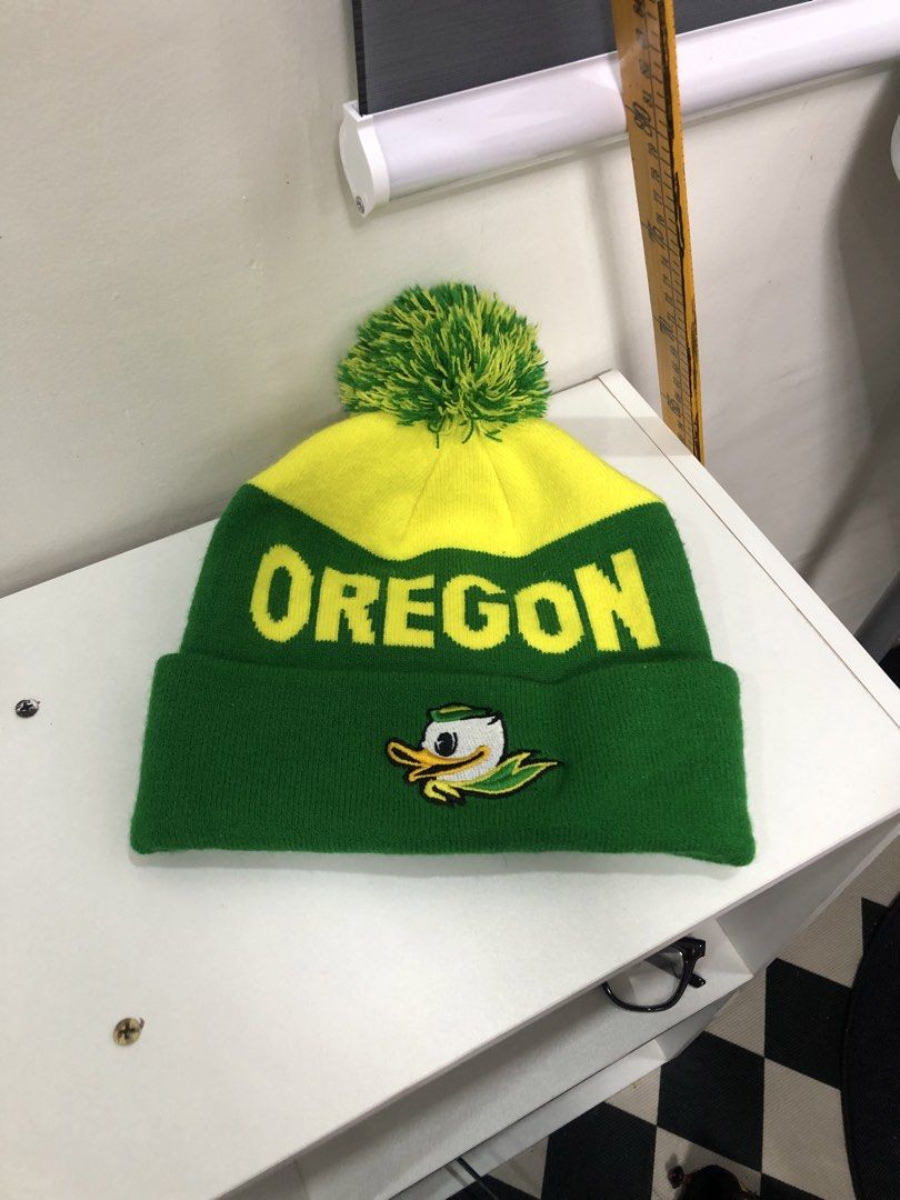 Nike Oregon Ducks Pom Beanie Green Yellow (Category: Caps & Hats) located in Manila. Submitted by ejaay_2012 (Listing ID 1470104206, Image 1). Description: - Authentic Nike Oregon Ducks winter beanie - Eye-catching green and yellow knit design with a playful pom pom - Features bold OREGON text on the front and DUCKS text on the back - Detailed Oregon Duck logo embroidery and Nike swoosh tag on the cuff - Made from 100% acrylic for maximum warmth 