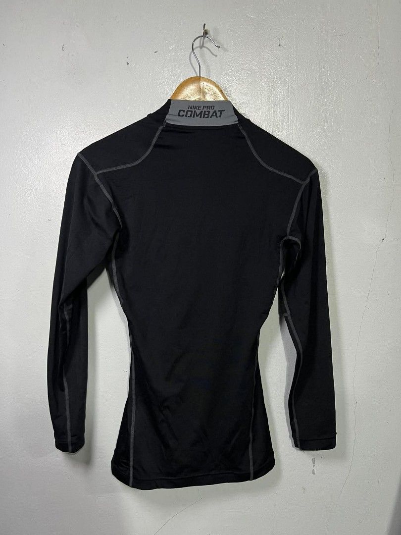 Nike Pro Combat Dri-Fit Compression Shirt Black Medium (Category: Activewear) located in Roxas, Mindoro Oriental. Submitted by oldschool_thriftph (Listing ID 1470108967, Image 2). Description: - Brand/Model: Nike Pro Combat Compression Shirt - Color: Black with grey detailing - Size: Medium - Dimes 15x25 - Style Code: 449833-010 - Material: Dri-FIT fabric for moisture-wicking and dry workouts - Design: Mock neck with branding on collar and lower 