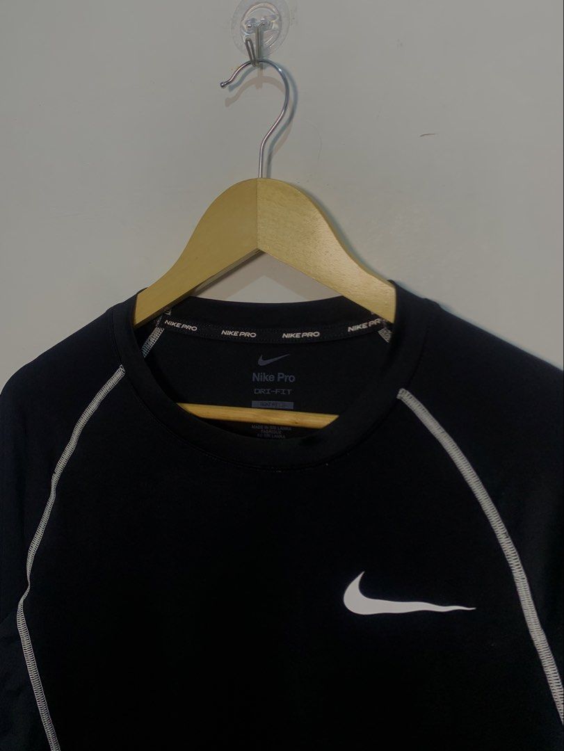Nike Pro Dri-FIT Long Sleeve Compression Shirt (Category: Activewear) located in Davao. Submitted by legitseller1111 (Listing ID 1470128133, Image 3). Description: - Brand: Nike Pro - Type: Long sleeve compression top - Color: Black with white contrast stitching and branding - Material: Dri-FIT moisture-wicking fabric - Details: White Nike swoosh on chest, large swoosh on sleeve, Nike Pro inner collar taping, and bold text on back neckline - Fit: