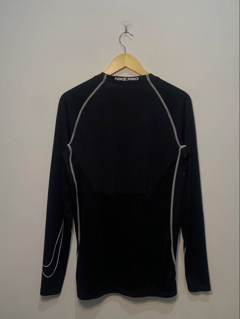 Nike Pro Dri-FIT Long Sleeve Compression Shirt (Category: Activewear) located in Davao. Submitted by legitseller1111 (Listing ID 1470128133, Image 2). Description: - Brand: Nike Pro - Type: Long sleeve compression top - Color: Black with white contrast stitching and branding - Material: Dri-FIT moisture-wicking fabric - Details: White Nike swoosh on chest, large swoosh on sleeve, Nike Pro inner collar taping, and bold text on back neckline - Fit:
