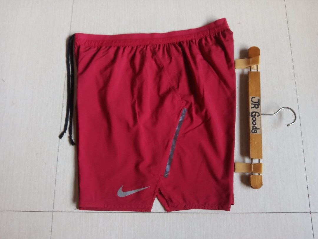 Nike Red Running Shorts (Category: Activewear) located in Tanay. Submitted by jrgoods (Listing ID 1470011803, Image 2). Description: Nlke dri-fit short XL fits large men's Above the knee Waistline 32-36 length 17.5 Good as new condition 750+ship Tanay Rizal location Shipping Nationwide - Condition: Brand new with store tags attached - Color: Red with black drawstrings - Features: Reflective silver Nike swoosh for visibility - Pocket: Convenient z