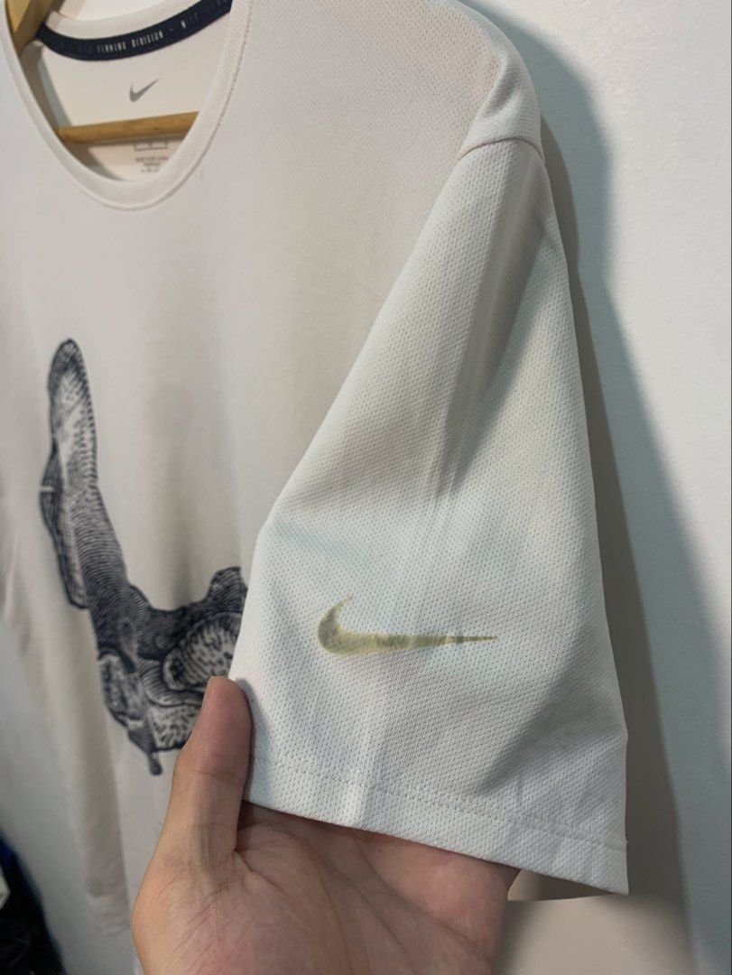Nike Running Division Bone Graphic T-Shirt (Category: Tshirts & Polo Shirts ) located in Davao. Submitted by legitseller1111 (Listing ID 1470126258, Image 3). Description: - Brand: Nike Running Division - Color: Off-white - Size: Medium on Tag Can fit Up to Large - Material: Dri-FIT, breathable fabric - Design: Vintage-style anatomical foot and bone graphic wrapping front and back, with small swoosh on left sleeve - Condition: Clean, minimalist a