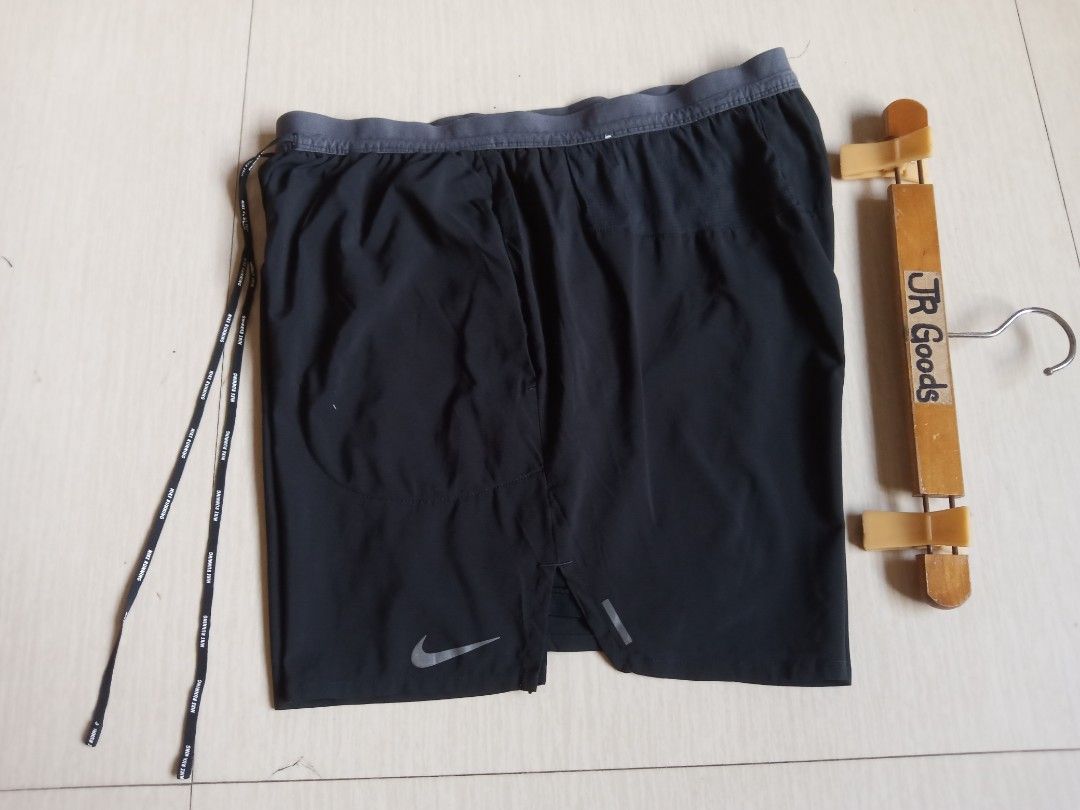 Nike Running Shorts Black (Category: Activewear) located in Tanay. Submitted by jrgoods (Listing ID 1470091008, Image 2). Description: Nlke running Fits medium to Large men's above the knee Waistline 32-34 Length 16 Excellent to new condition 599+ship Tanay Rizal location Shipping Nationwide - Color: Black with grey waistband and branded drawstring - Condition: Good, clean stitching - Features: Reflective swoosh logo for visibility - Storage: Sid