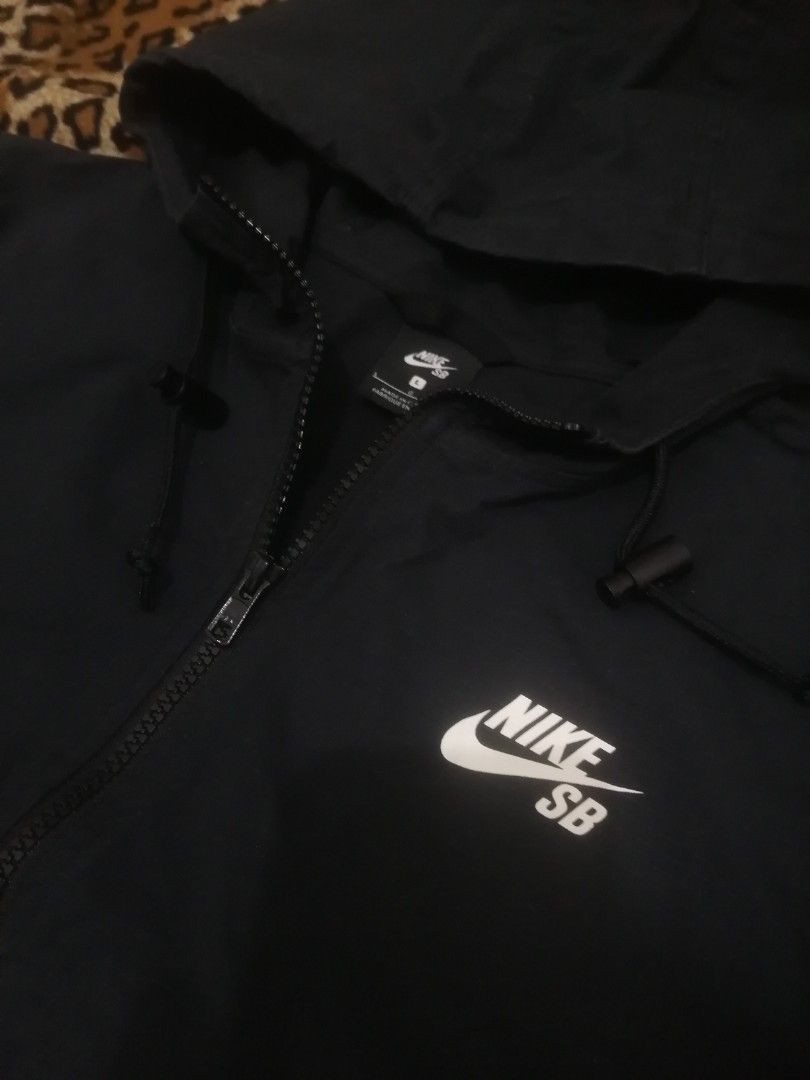 Nike SB Black Anorak Hoodie Jacket (Category: Coats, Jackets and Outerwear) located in Cebu City. Submitted by roadthrift (Listing ID 1470135299, Image 2). Description: - Brand: Nike SB - Item: Anorak Jacket with Hood - Color: Black with white chest logo - Size: L (fits height 170-180 cm) - Material: 97% cotton, 3% spandex - Features: Half-zip front, front kangaroo pocket, adjustable hood drawstrings - Condition: Clean and well-maintained.