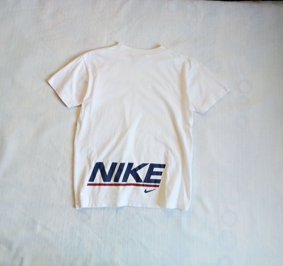 Nike swoosh over script white vintage tee (Category: Shirts) located in Bagabag. Submitted by thrift_stories96 (Listing ID 1470110464, Image 1). Description: Nike swoosh over script white vintage tee for her Small Length - 20.5 Width - 17.5 Condition - 8.5/10 Color rate - 9/10 Flaw - fine lints,tiny pinhole sa chest bandang ibaba ng check..