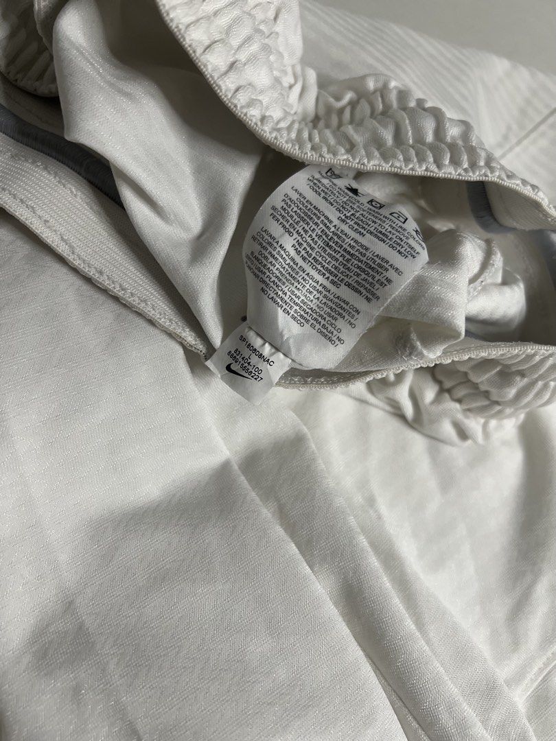 Nike White Athletic Shorts Size L (Category: Shorts) located in Tacloban City. Submitted by thrftg (Listing ID 1470086873, Image 3). Description: - Brand: Nike - Color: White with black embroidered swoosh logo - Size: Large - Material: Lightweight, clean fabric made in Thailand - Features: Elastic waistband with drawstring and convenient side pockets.