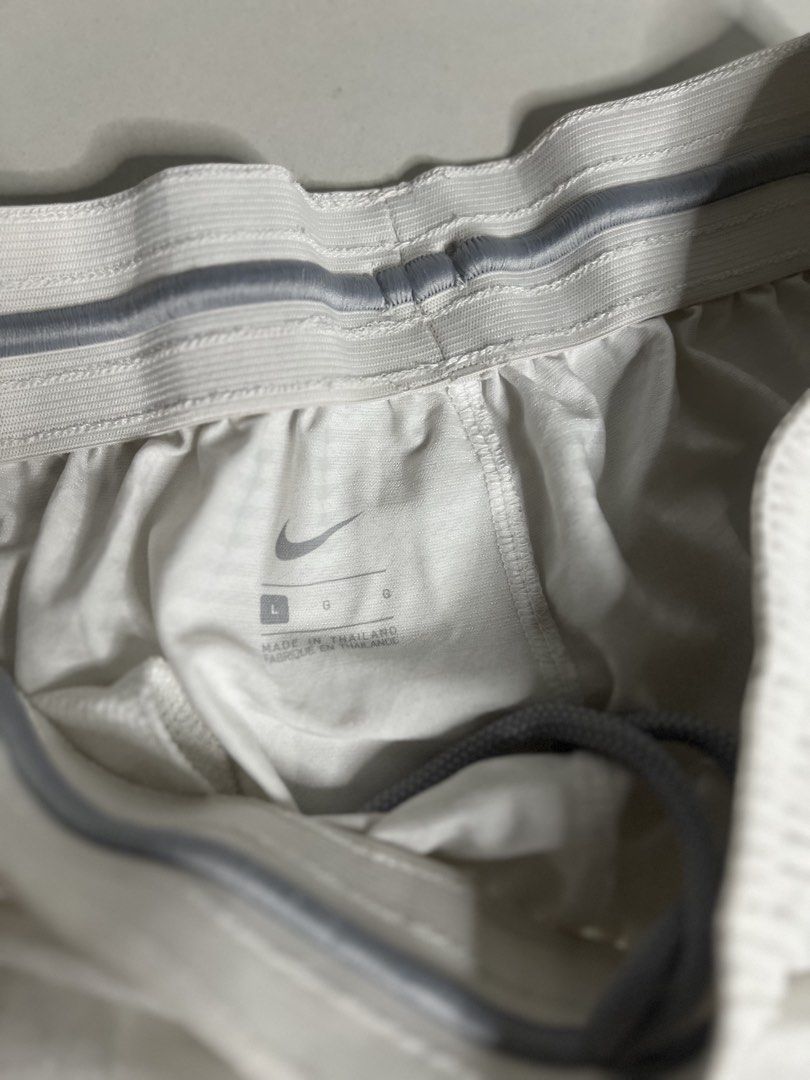Nike White Athletic Shorts Size L (Category: Shorts) located in Tacloban City. Submitted by thrftg (Listing ID 1470086873, Image 2). Description: - Brand: Nike - Color: White with black embroidered swoosh logo - Size: Large - Material: Lightweight, clean fabric made in Thailand - Features: Elastic waistband with drawstring and convenient side pockets.